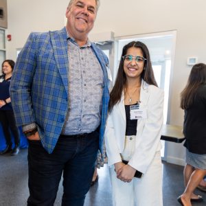 Close-up of two professionals smiling at the Clarington Board of Trade conference.