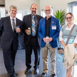 Group of business professionals at Clarington Board of Trade meeting, engaging in networking and socializing.