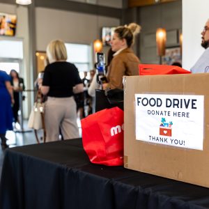 Food drive box labeled "Donate Here" at Clarington Board of Trade community event, promoting local charity efforts.