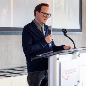 Image of a man giving a speech at Clarington Board of Trade event, focusing on local economic development.