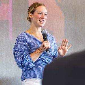 A woman speaking at the Clarington Board of Trade event, engaging with local business community.