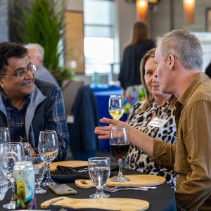 A diverse group of business professionals engaging in conversation at a Clarington Board of Trade networking event, fostering local business connections.