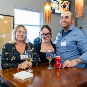 Friendly business professionals enjoying drinks together.
