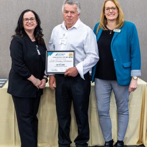 Photo of award recipient with Board of Trade representatives at Clarington event.