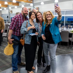 A group of diverse professionals taking a selfie at the Clarington Board of Trade event.