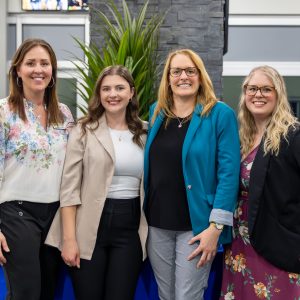 Smiling businesswomen posing at a local networking event for Clarington commerce.