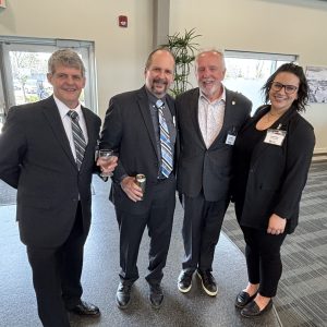 Group of diverse professionals at a Clarington Board of Trade event, smiling and networking.