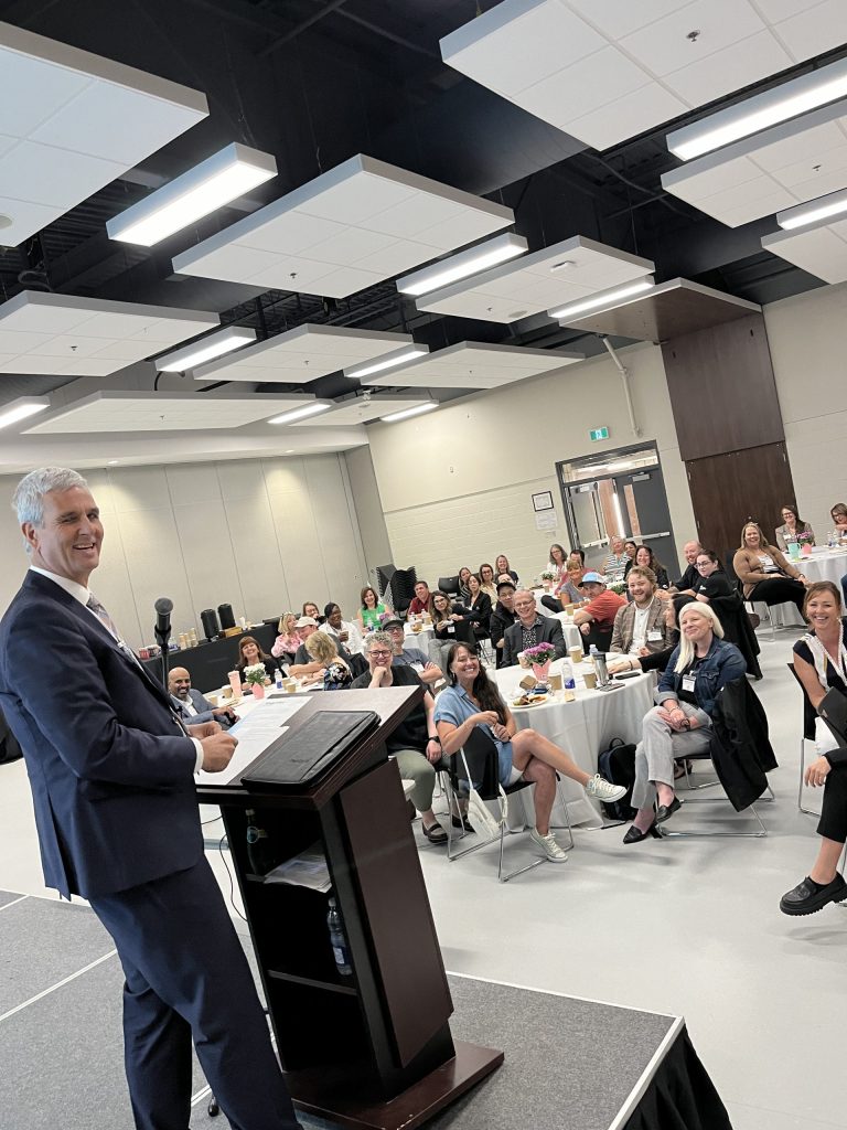 Professional speaker addresses a corporate audience at a networking event.