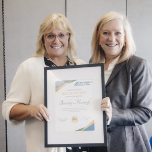 Two women holding a recognition certificate at Clarington Board of Trade event.