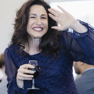 Woman smiling and waving at Clarington Board of Trade event.