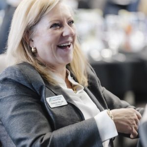 Woman smiling at Clarington Board of Trade event, networking and business growth.