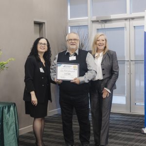 Clarington Board of Trade award presentation with three professionals at event.