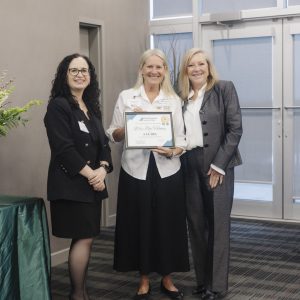 Award presentation at Clarington Board of Trade event with three women smiling.