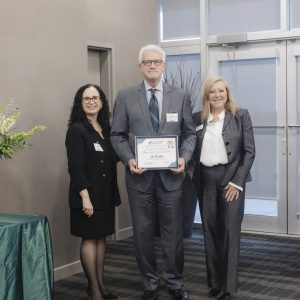 Clarington Board of Trade award presentation with three professionals in business attire.