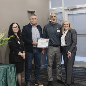 Group of professionals at Clarington Board of Trade event, celebrating business achievements.