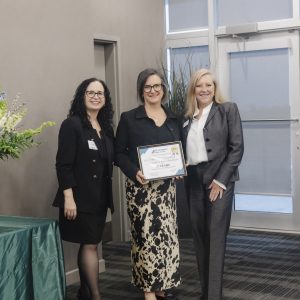 Three women at Clarington Board of Trade event, one holding an award certificate.