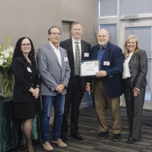 Group of professionals at Clarington Board of Trade event, holding award certificate.