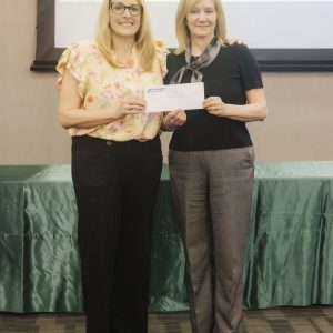 Two women at Clarington Board of Trade event exchanging a check.